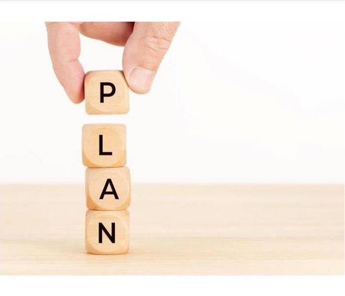 Wooden blocks stacked on top of each other to spell PLAN.